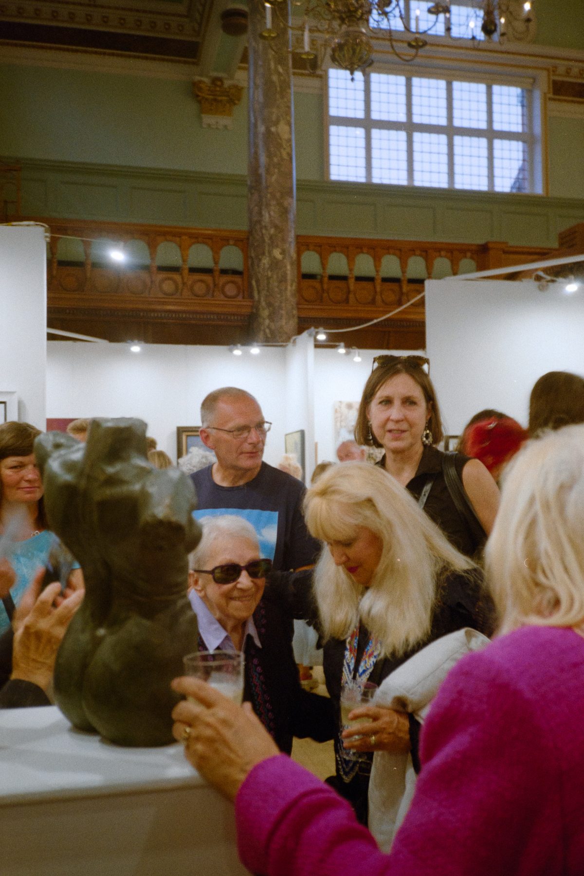 Visitors chatting around Vega at the London Art Biennale, 2023